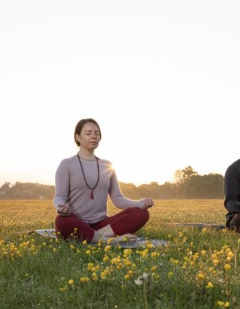man-woman-doing-yoga-together-outdoors